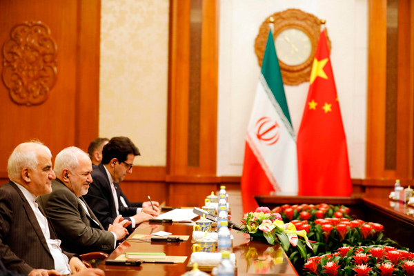 Iranian Foreign Minister Mohammad Javad Zarif (second left) speaks with Chinese Foreign Minister Wang Yi (not seen) at the Diaoyutai State Guesthouse in Beijing on Sunday  (AFP photo)