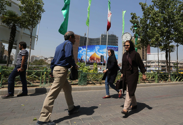 People walk in the Vali Asr Square in the Iranian capital Tehran, on Tuesday  (AFP photo)