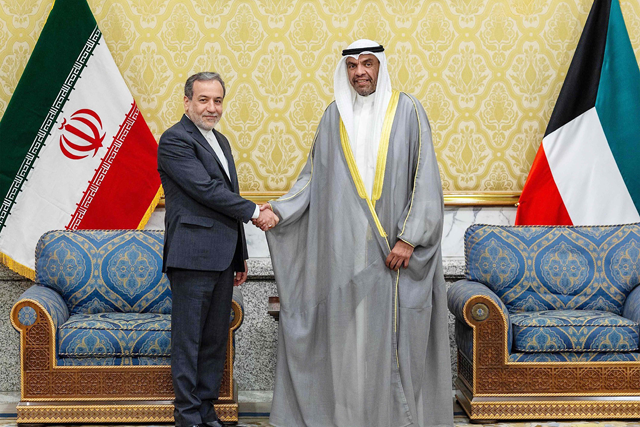 This handout photo provided by the Kuwaiti news agency KUNA shows Kuwait's Foreign Minister Abdullah Al Yahya (right) receiving Iran's Foreign Minister Abbas Araghchi in Kuwait City on Tuesday (AFP photo)