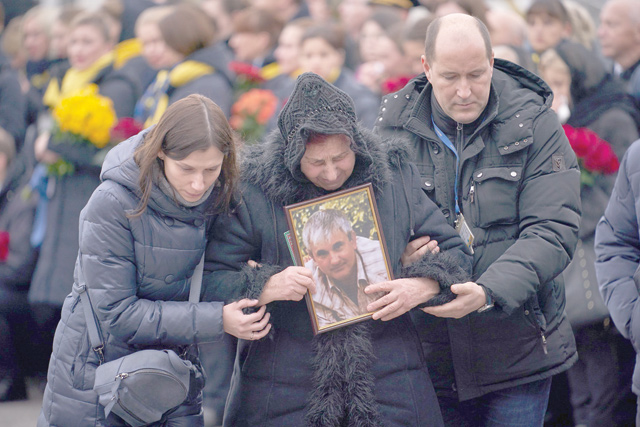 This handout photo taken and released by the Ukrainian presidential press service on January 19, shows relatives and colleagues as they attend a tribute ceremony at Kiev's Boryspil airport for the 11 Ukrainians who died in a plane mistakenly shot down by Iran during a spike in tensions with Washington (AFP photo)