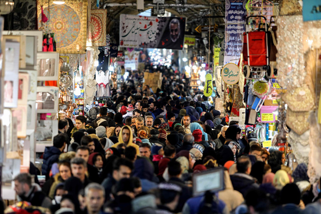 People walk along an alley at the historical Grand Bazaar in the Iranian capital Tehran, on Wednesday  (AFP photo)