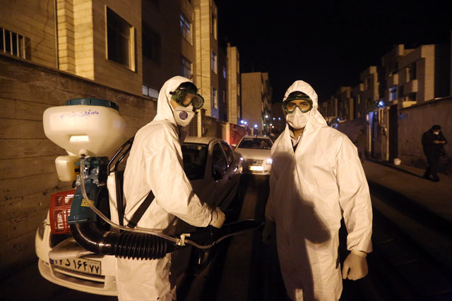 Iranian firefighters disinfect streets and allies in southern Tehran to halt the wild spread of coronavirus on Wednesday (AFP photo)