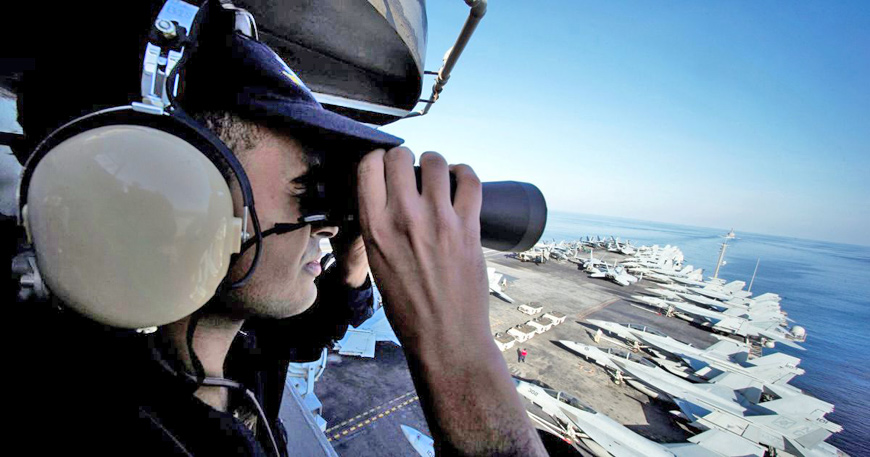 A US sailor keeps watch from the captain's bridge onboard the USS John C. Stennis as it makes its way to the Gulf through the Strait of Hormuz on Friday (Reuters photo)