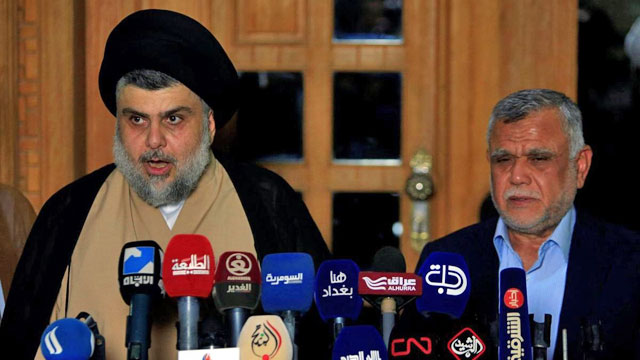 Iraqi Shiite cleric Moqtada Al Sadr speaks during a news conference with leader of the Conquest Coalition and the Iran-backed Shiite militia Badr Organisation Hadi Al Amiri in Najaf, Iraq, on June 12 (Reuters photo)