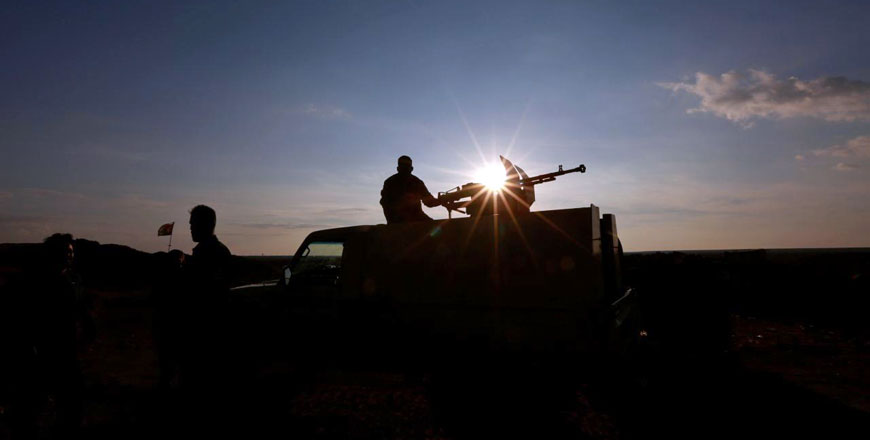 A Popular Mobilisation Forces fighter rides in a military vehicle at the Iraqi-Syrian border near Al Qaim, Iraq, on November 26 (Reuters photo)