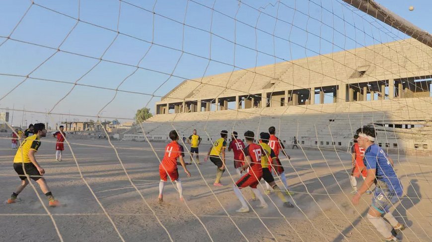 Football players train on the dusty pitch of the Al Idara Al Mahalia Stadium in Mosul which was once used by Daesh terror group as a weapons depot and a launchpad for rocket and mortar attacks (AFP photo)