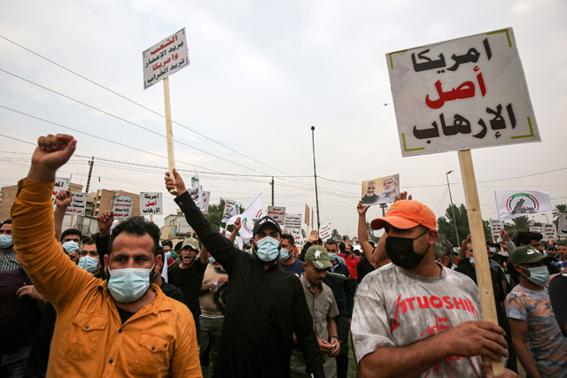 Supporter of the Iran-backed Hashed Al Shaabi (Popular Mobilisation) paramilitary forces chant slogans during a demonstration outside the entrance to the Iraqi capital Baghdad's highly-fortified Green Zone on Saturday, demanding the departure of remaining US forces from Iraq (AFP photo)