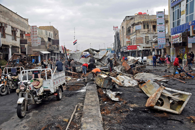This photo taken on Saturday shows a view of people cleaning up at a protest site in Habboubi Square in Iraq's southern city of Nasiriyah (AFP photo)