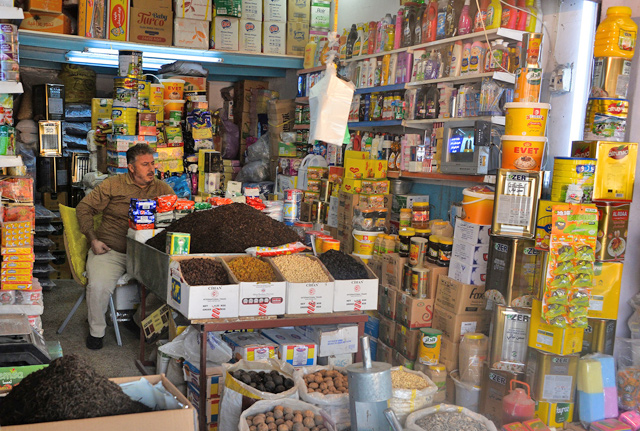 An Iraqi salesman sits at a shop at Al Bursa wholesale market in the northern city of Mosul, on November 28  (AFP photo)