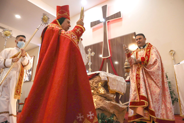 Iraqi priests hold the Christmas Eve mass at the Sultana Church in the Ankawa suburb north of Erbil, the capital of the autonomous Kurdish region of northern Iraq, on Thursday  (AFP photo)