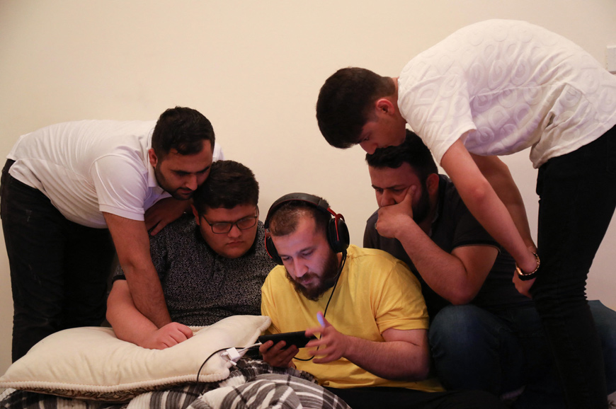 Iraqi Kurdish youths play the PUBG video game on his mobile phone in Erbil, the capital of the autonomous Kurdish region in northern Iraq, on May 1  (AFP photo)
