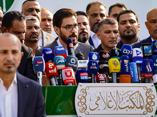 A member of the Iraqi Sadrist bloc (of Shiite leader Moqtada Sadr) announces the party's electoral programme for the upcoming elections, in the central city of Najaf, on Thursday (AFP photo)