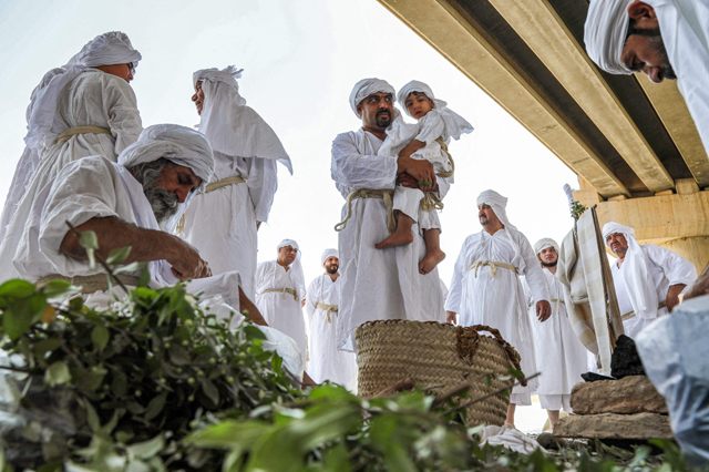 Sabean worshippers, followers of a pre-Christian religion which considers the prophet Abraham as one of the founders of their faith, take part in a cleansing ritual known as the ‘Golden Cleansing’, along the banks of the Great Zab River in the Kurdish town of Khabat, some 40 kilometres west of Erbil, in the autonomous Kurdish region of northern Iraq, on Wednesday  (AFP photo)