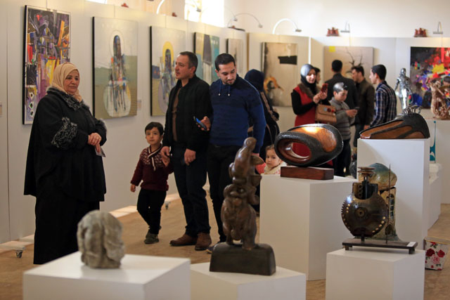 People look at the painting and sculpture during an art exhibition at the Mosul Museum Hall in Mosul, Iraq, on Wednesday (Reuters photo)