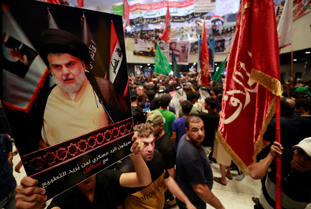 Supporters of Iraqi cleric Moqtada Sadr, protesting against a rival bloc's nomination for prime minister, continue their sit-in inside Iraq's parliament in the capital Baghdad's high-security Green Zone, on Tuesday (AFP photo)
