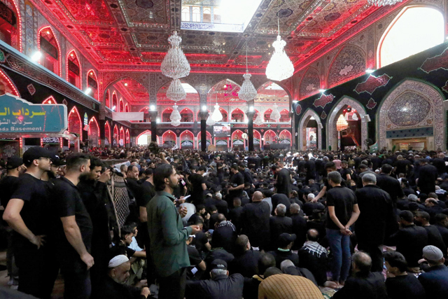 Shiite Muslims attend an Ashura mourning session at the shrine of the reverred Imam in Iraq’s holy city of Karbala, on Tuesday (AFP photo)
