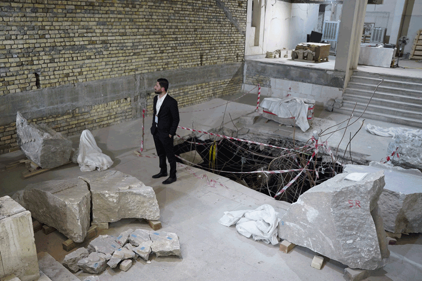 A man looks at broken artifacts at the Mosul Museum in Iraq’s northern city, on Thursday (AFP photo)