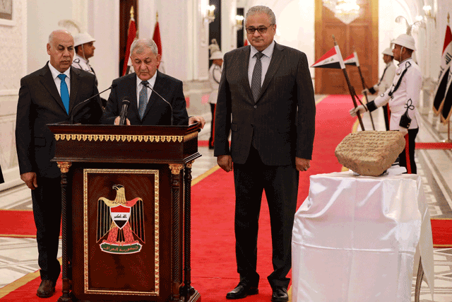 Iraqi President Abdul Latif Rashid (centre) flanked by Culture Minister Ahmed Fakak Al Badrani (left) and the Director of the Iraqi Council of Antiquities and Heritage Laith Majid Hussein, speaks during a press conference in Baghdad, during which a 2,800-year-old stone tablet was unveiled after it was handed over by the Italian authorities to the Iraqi president during his recent visit to Bologna, on Sunday (AFP photo)
