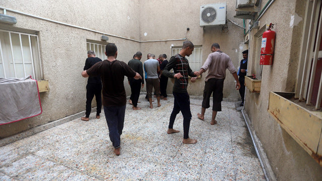 Iraqi suspects who were arrested for drug-related crimes exercise outside a cell of a police station in Basra, Iraq, on December 18, 2018 (Reuters photo)