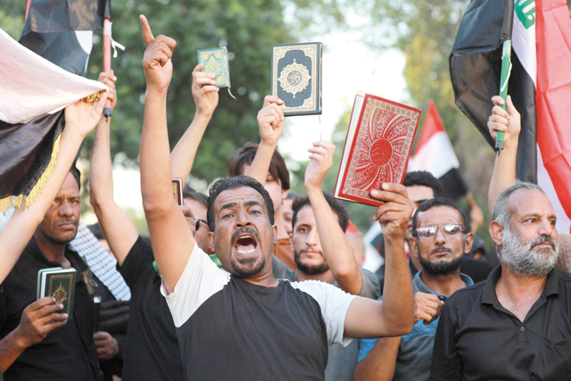 Supporters of Iraq's Hashed Al Shaabi (Popular Mobilisation) group take part in a protest denouncing the burning in Sweden of the Koran, Islam's holy book, in Al Jadiriyah area near Baghdad's Green Zone, on Saturday (AFP photo)
