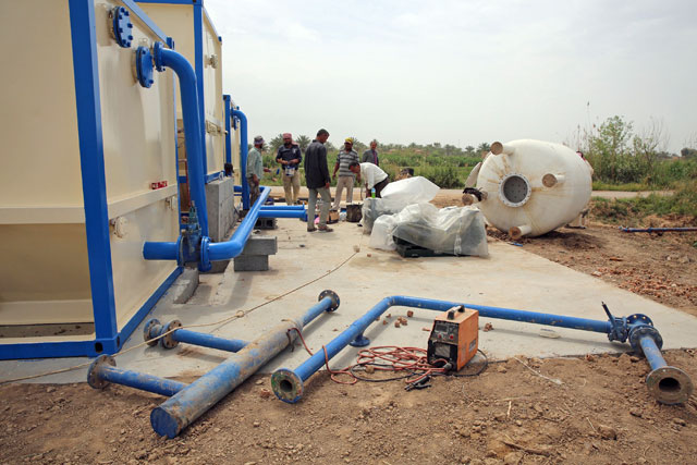Workers check broken pipes at Mashahada pumping station, north of Iraq’s capital Baghdad, on April 19 (AFP photo)