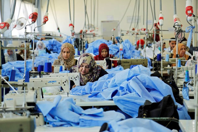 Women sew clothes at Waladi textile factory, part of which was destroyed by the war, in Mosul, Iraq, on May 5 (Reuters photo)