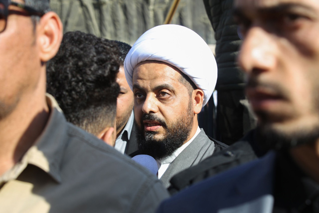 Qais Al Khazali, leader of Asaib Ahl Al Haq faction, attends the funeral procession of Hashed Al Shaabi fighters in Baghdad on Tuesday, who were killed on the weekend in US air strikes on a base in western Iraq near Al Qaim, on the border with Syria  (AFP photo)