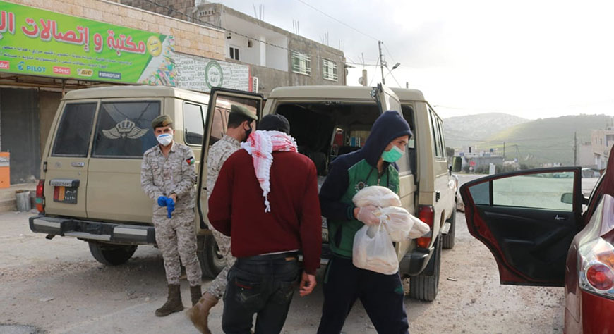 Army personnel distribute bread and fuel in Al Jahfiya village in Irbid governorate on Saturday (Petra photo)