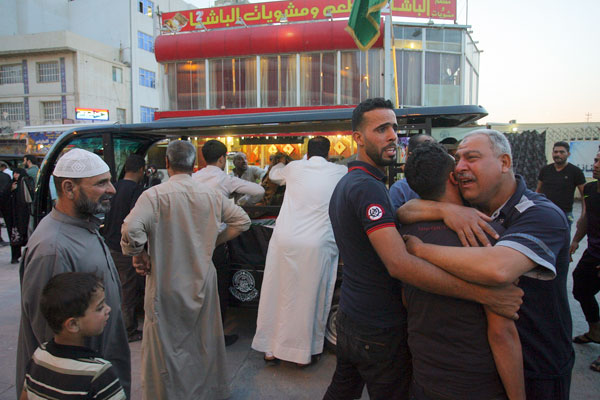Mourners grieve during the funeral procession of bomb victims, Murtada Mohammed, 26, and his brother Sadiq Mohammed, 22, during their funeral procession in Najaf, 160 kilometres south of Baghdad, Iraq, Wednesday (AP photo)