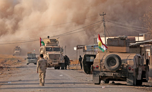 Smoke rises during clashes between peshmerga forces and Daesh militants in the town of Bashiqa, east of Mosul, on Monday (Reuters photo)