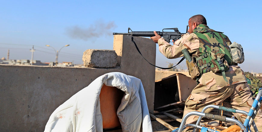 An Iraqi soldier fires his weapon towards Daesh militants at the front line in the Shaimaa neighbourhood of Mosul, Iraq, Sunday (AP photo)