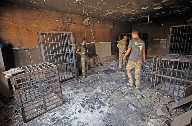 Members of the Iraqi police inspect a prison previously used by the Daesh terror group in the city of Fallujah on Thursday after the city was recaptured by government forces (AFP photo)