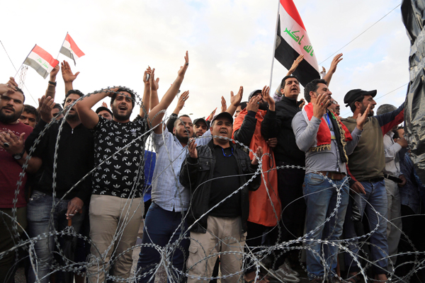 Followers of Shiite cleric Muqtada Al Sadr hold a sit-in outside the heavily guarded Green Zone in Baghdad, Iraq, on Monday (AP photo)