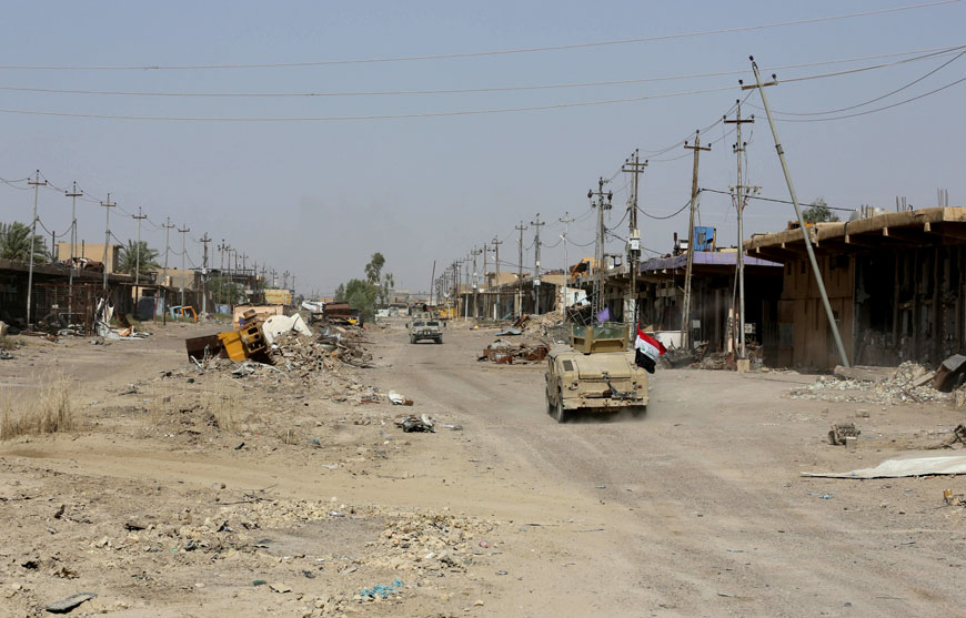 In this June 22 photo, Iraqi forces advance in Fallujah, Iraq (AP photo)