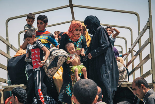 In this August 17 photo, civilians who recently fled territory formerly controlled by Daesh militants get off a truck at the Dibaga Camp for displaced people in Hajj Ali, northern Iraq (AP photo by Alice Martins)