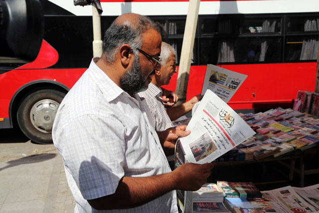 Iraqis read newspapers with the front-page headline reading ‘Turkey leads plans for the invasion of Iraq and Syria’ in Baghdad, Iraq, on Thursday (AP photo)