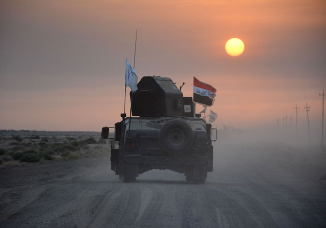 Pro-government forces drive in military vehicles in Iraq’s eastern Salaheddin province, south of Hawijah, on Monday, as they clear the area in preparation for the push to retake the northern Iraqi city of Mosul (AFP photo)