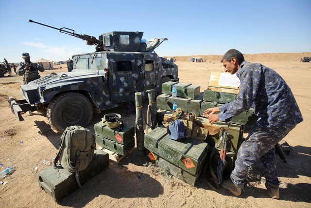 An Iraqi policeman unloads ammunition at the Qayyarah military base, about 60 kilometres south of Mosul, on Sunday, as they prepare for an offensive to retake Mosul, the last Daesh-held city in the country, after regaining much of the territory the extremists seized in 2014 and 2015 (AFP photo)