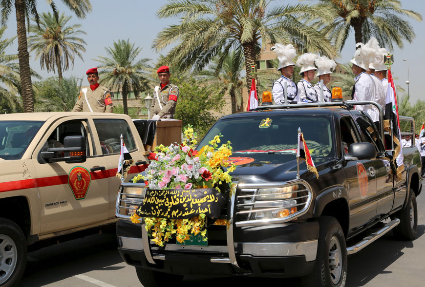 Military vehicles transport the coffins of Major General Abdul-Rahman Abu-Regheef and Brigadier General Sefeen Abdul-Maguid during their funeral ceremonies, at the defence ministry in Baghdad, on Thursday (Reuters photo)