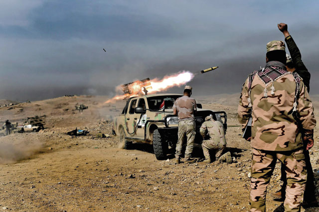 Members of the Iraqi army’s 9th Division fire a multiple rocket launcher from a hill in Talul Al Atshana, on the southwestern outskirts of Mosul, on Monday, during an offensive to retake the city from Daesh extremists (AFP photo)