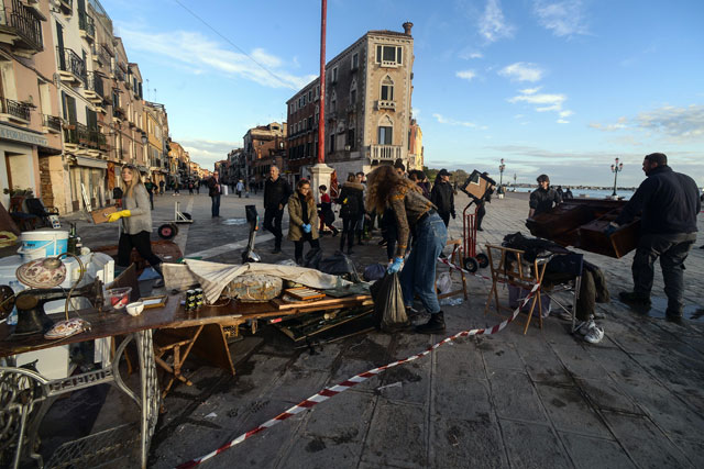 People gather damaged items and furniture on Thursday in Venice, after the city suffered its highest tide in 50 years (AFP photo)