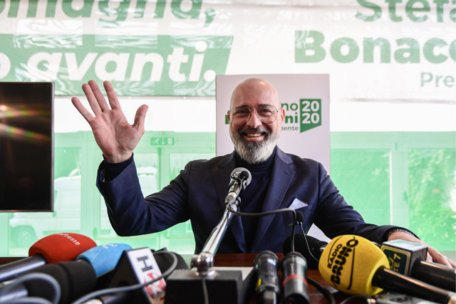 Incumbent centre-left candidate of the Democratic Party (PD) in a regional vote in Emilia-Romagna, Stefano Bonaccini waves as he addresses a press conference on Monday (AFP photo)