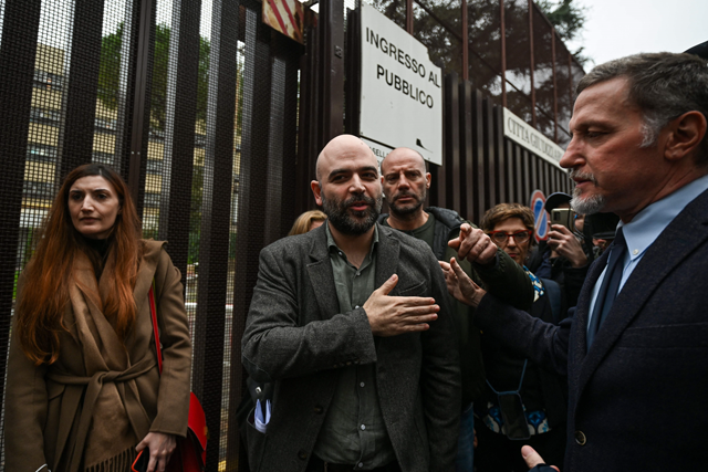 Italian writer Roberto Saviano (centre) leaves on Tuesday the City of Justice (Citta Giudiziaria) in Rome, following a hearing in a defamation lawsuit from Italy’s current prime minister. Italian journalist Roberto Saviano, known for his fight against the mafia, is facing a defamation lawsuit  (AFP photo)