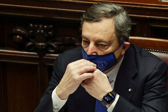 Italy's new Prime Minister Mario Draghi adjusts his face mask as he attends a lower Chamber session in the Italian Parliament on Thursday in Rome, before submitting his government to a vote of confidence (AFP photo)