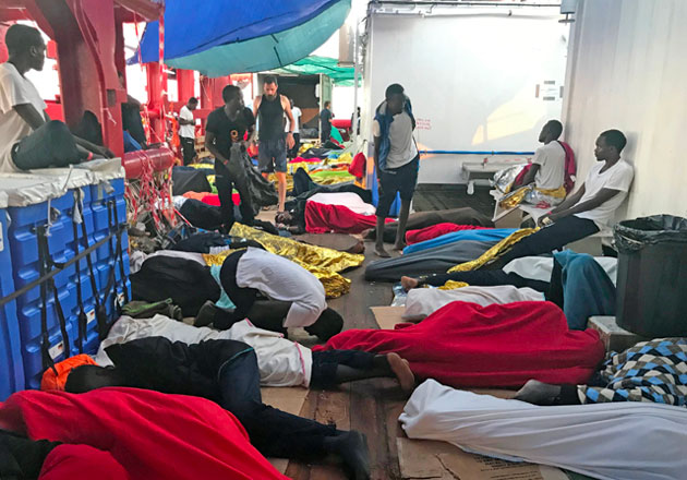 Rescued migrants sleep on deck of the 'Ocean Viking' rescue ship, jointly operated by French NGOs SOS Mediterranee and Medecins sans Frontieres, on Saturday (AFP photo)