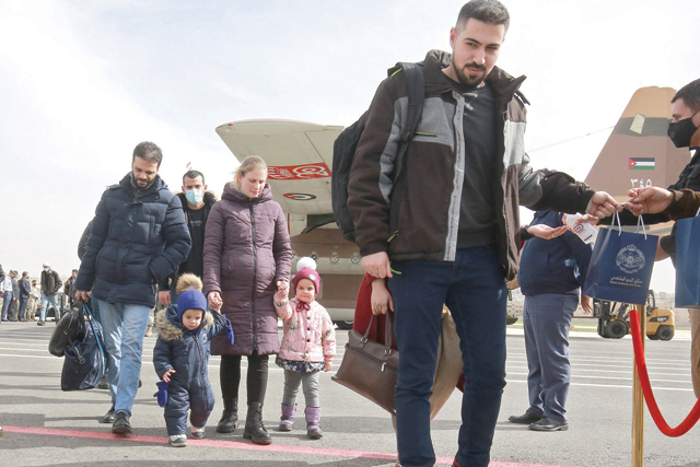 Jordanian nationals who fled the war in Ukraine arrive at Marka military airport on the northeastern outskirts of the capital Amman upon their evacuation by a military flight from Romania on Wednesday (AFP photo by Khalil Mazraawi)