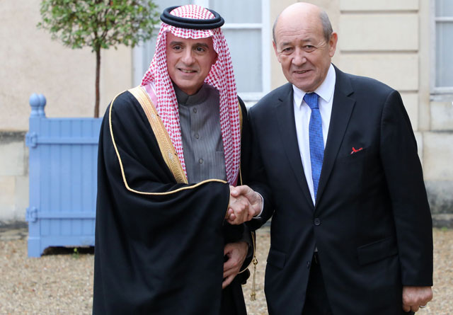 Saudi foreign affairs minister, Adel Al Jubeir (left), is welcomed by French foreign affairs minister,  Jean Yves Le Drian, upon his arrival for a summit from the underfunded G-5 Sahel anti-terror coalition on Wednesday (AFP photo)