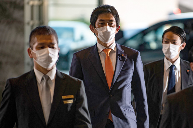 Japan’s minister for economic security Takayuki Kobayashi (centre) arrives at the prime minister’s office in Tokyo, on Monday (AFP photo)