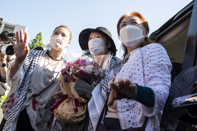Japan’s Red Army founder Fusako Shigenobu (centre) meets the media after her release from jail, flanked by her daughter May Shigenobu (left) and her lawyer (right) in Tokyo, on Satuday (AFP photo)