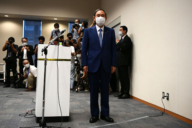 Japan’s Chief Cabinet Secretary Yoshihide Suga attends a press conference to announce his candidacy for the Liberal Democratic Party leadership in Tokyo, on Wednesday (AFP photo)